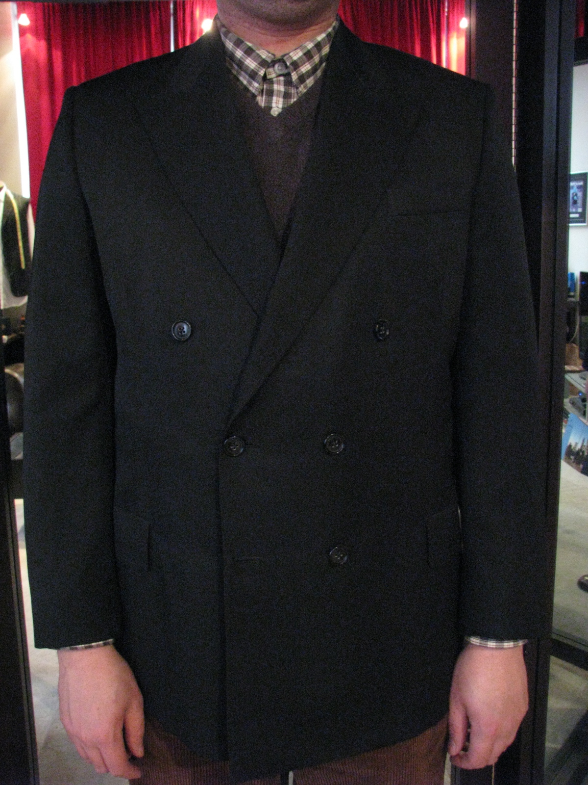 Man in dark double breasted custom made suit jacket