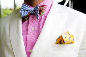cream jacket pink shirt with bow tie