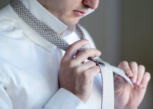 man tying a bow tie