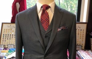 grey three piece mens suit on a mannequin