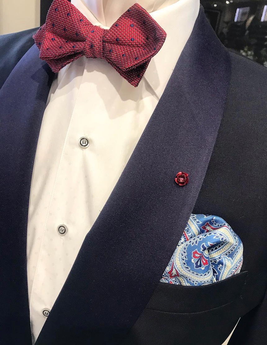 blue tuxedo and red bow tie on a mannequin