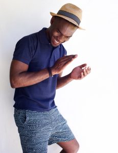 black man wearing blue shorts and hat