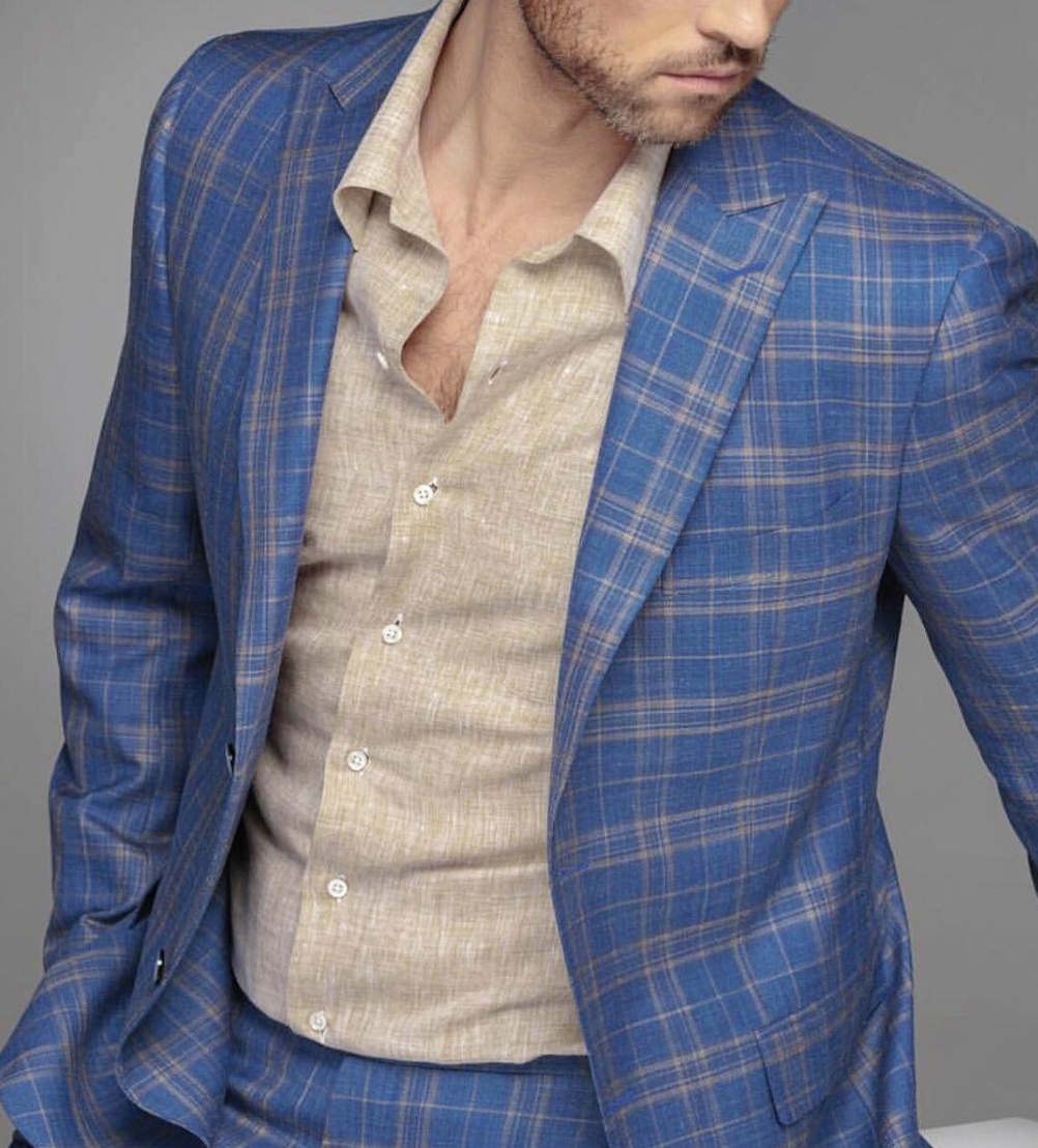 man wearing blue and tan plaid suit