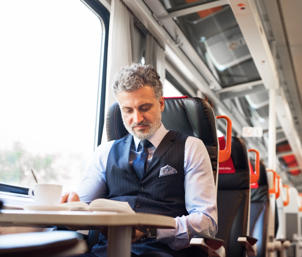man on train reading book