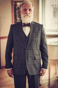 old man in three piece plaid suit