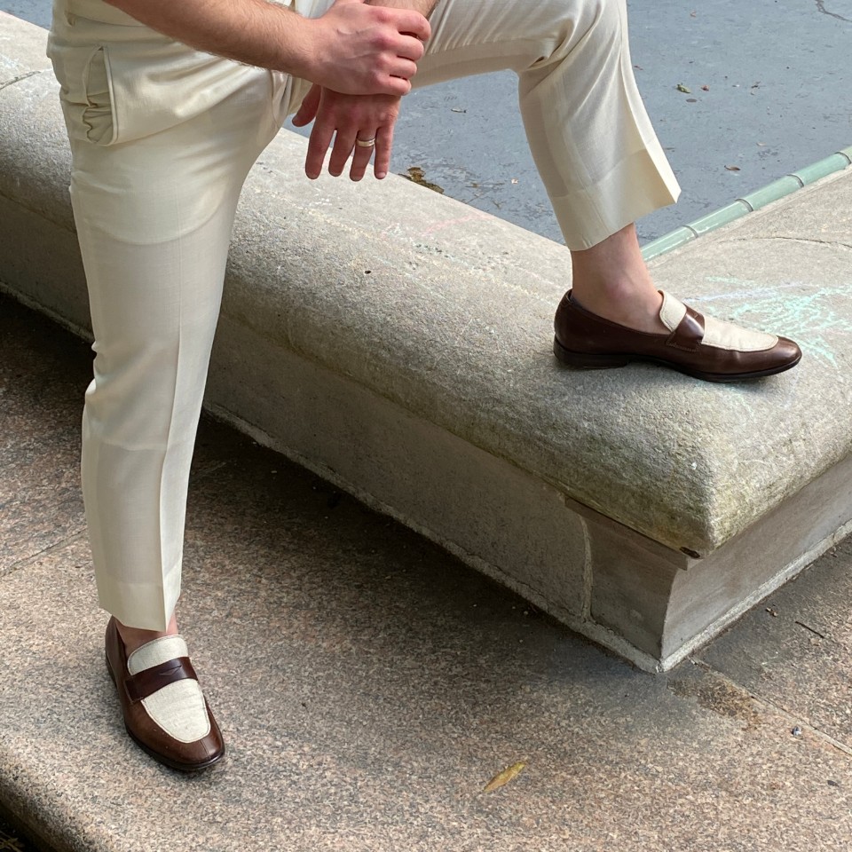 man posing in two tone penny loafers