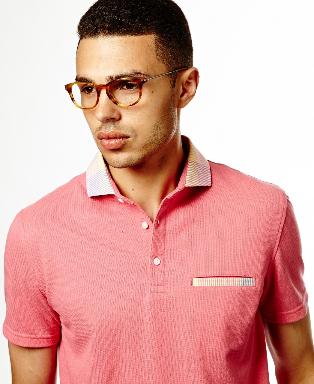 young man in glasses and pink polo shirt