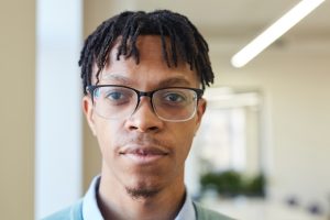 young black man in browline glasses