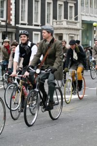 men wearing tweed on bicycles