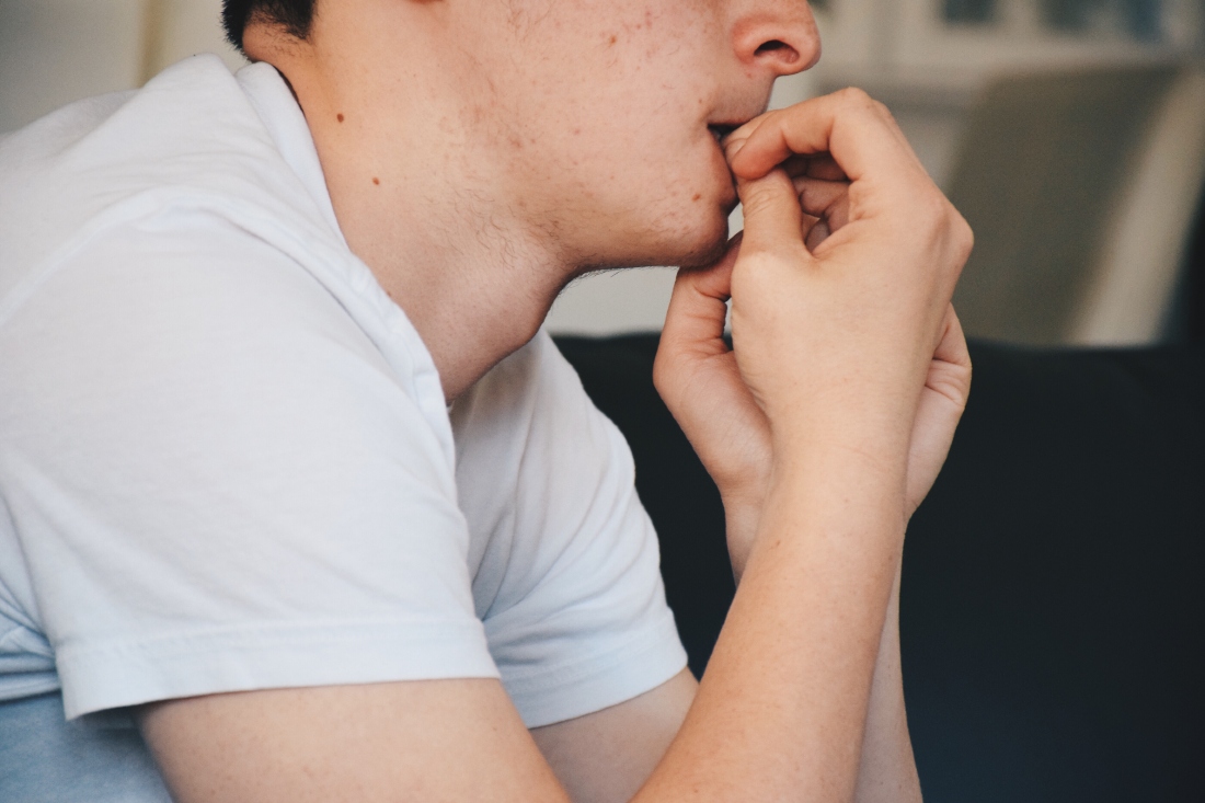 young man chewing nails