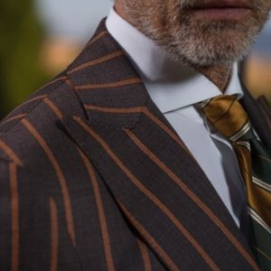 man in custom brown stripe suit