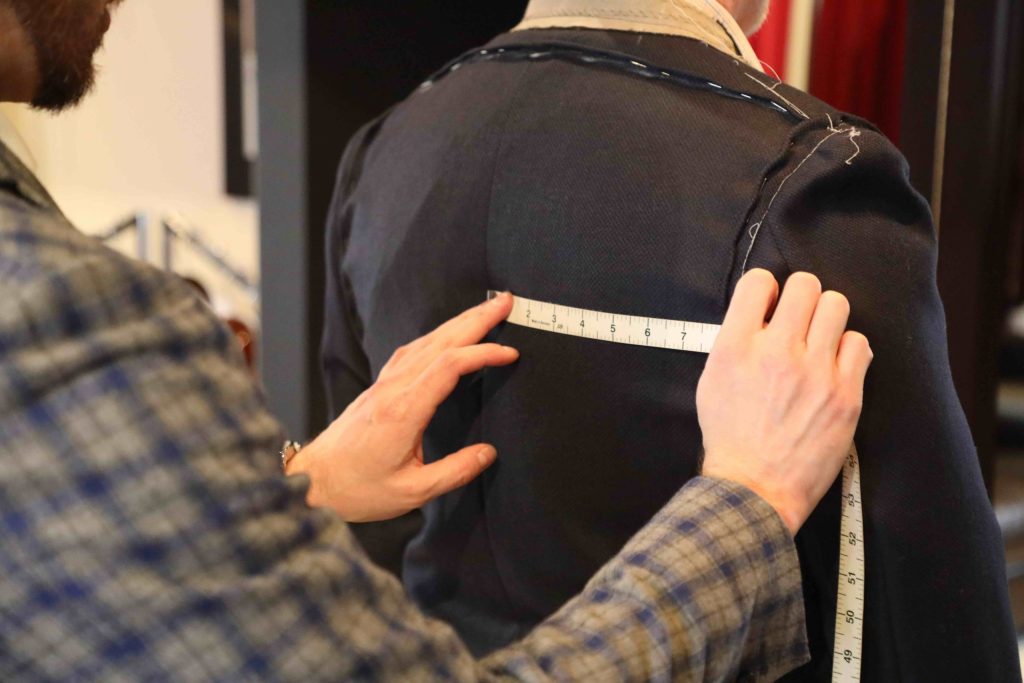 Man being pinned for jacket alteration