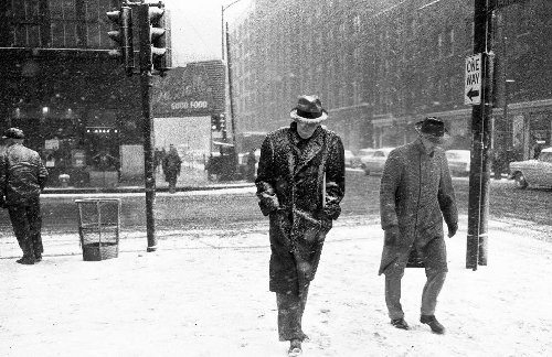 man walking in snowstorm