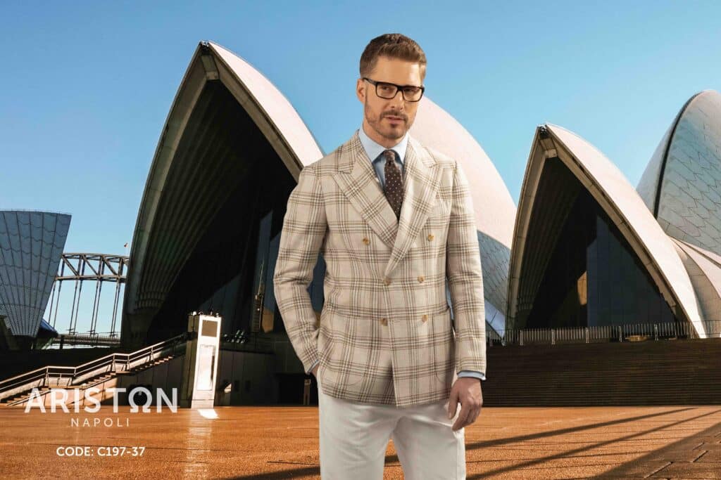 Man in a coat in front of the Sydney Opera House
