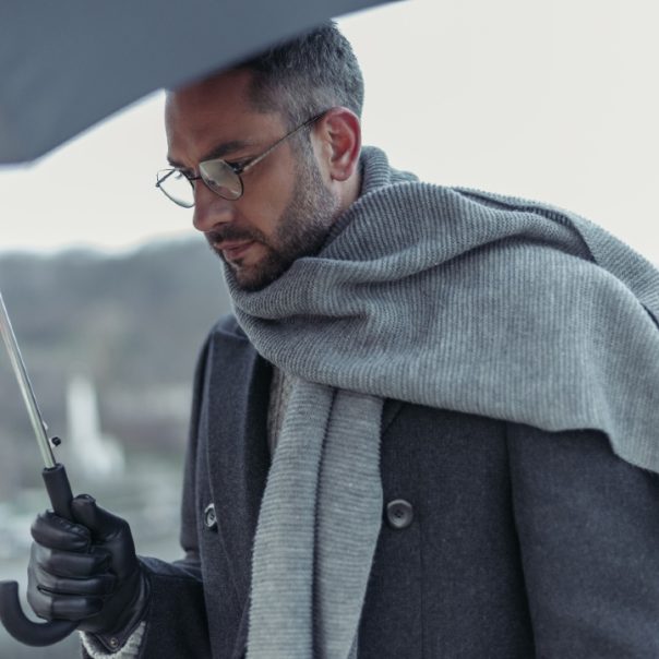 man-in-coat-and-scarf-with-umbrella
